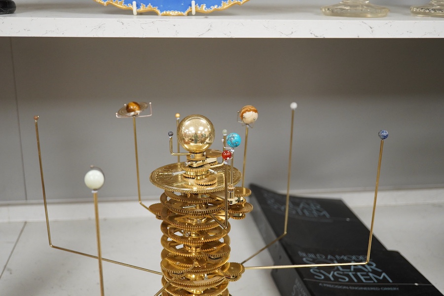 A precision brass orrery, a kit built electric operated astronomical orrery issued by Eaglemoss Publications as a part work ‘Build a Model Solar System’, complete with hardstone planets, brass moons, and a complete run o